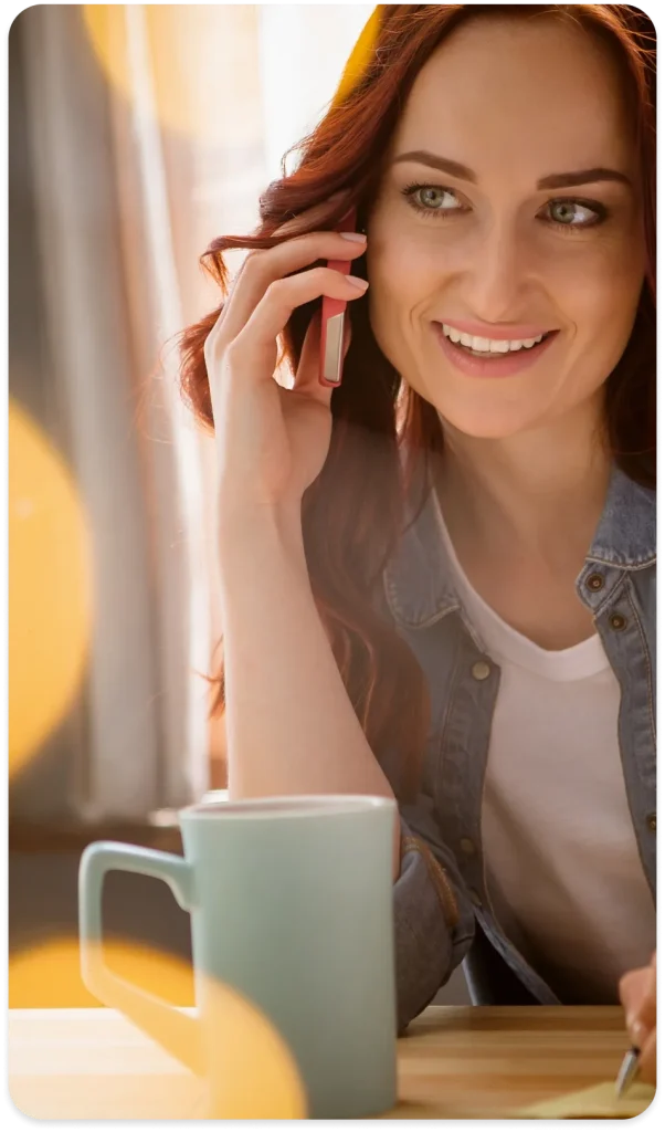 Femme souriante au téléphone — fonctionnalités de téléphonie d’entreprise Mia Cloud